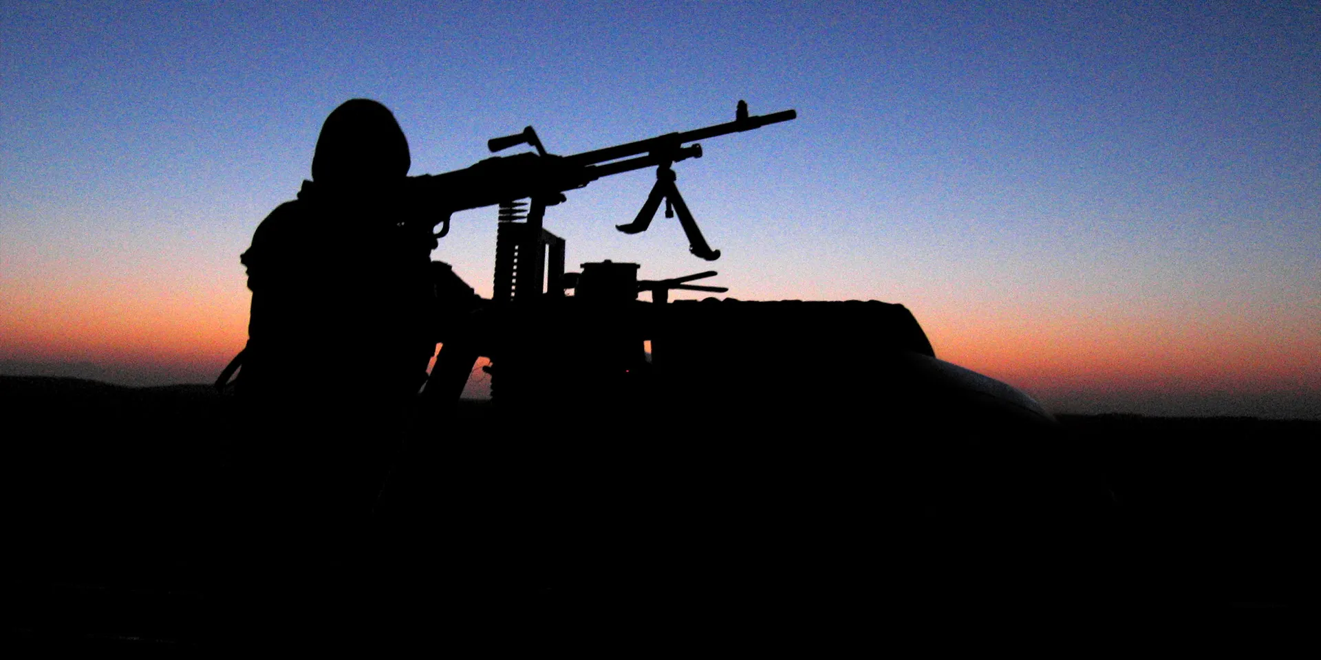 A night-time view of an SAS man on a weapons-mounted vehicle, c2005